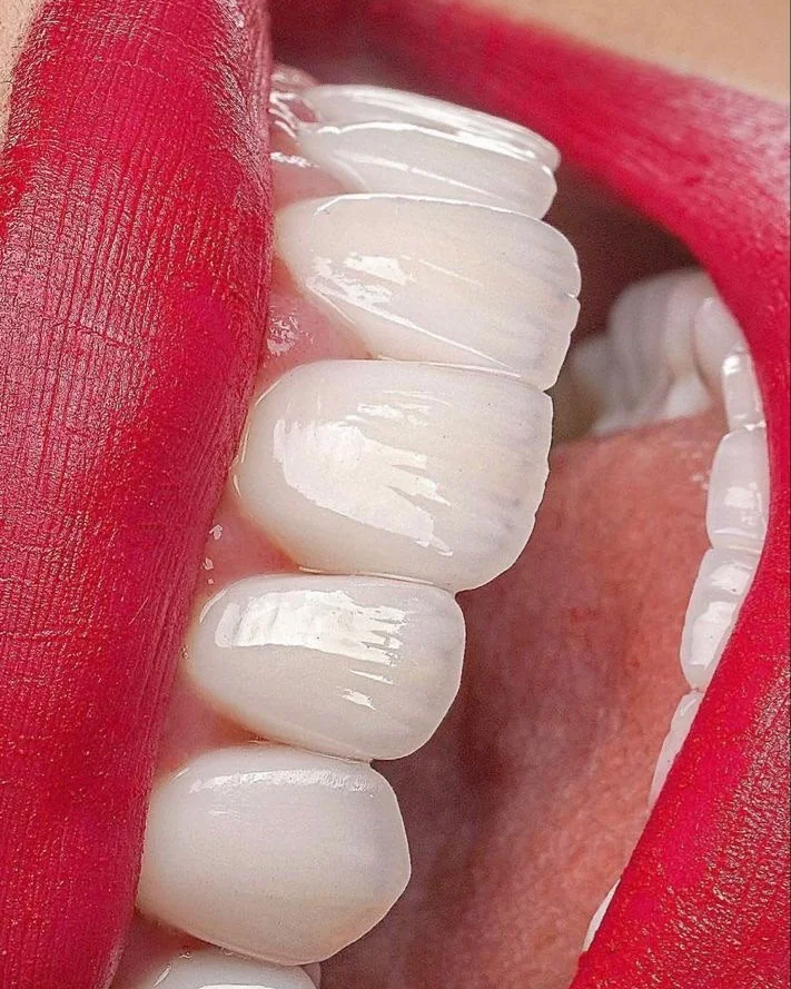 A bright smile with red lipstick, close up